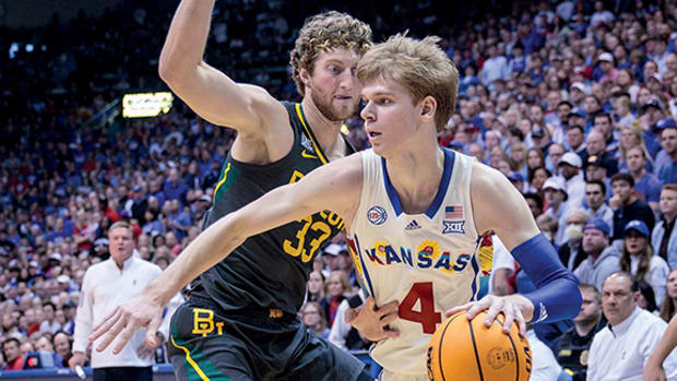 Kansas Jayhawks guard Gradey Dick drives around Baylor Bears forward Caleb Lohner during the second half at Allen Fieldhouse.